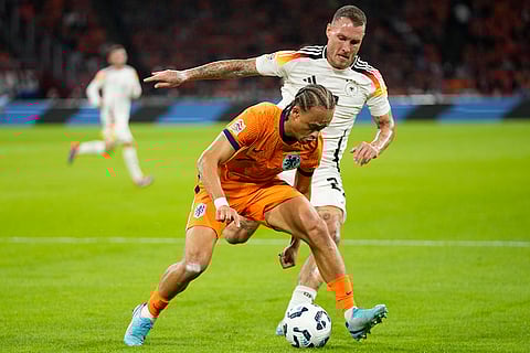 UEFA Nations League, Netherlands vs Germany: Xavi Simons of the Netherlands, left, and Germany's David Raum fight for the ball